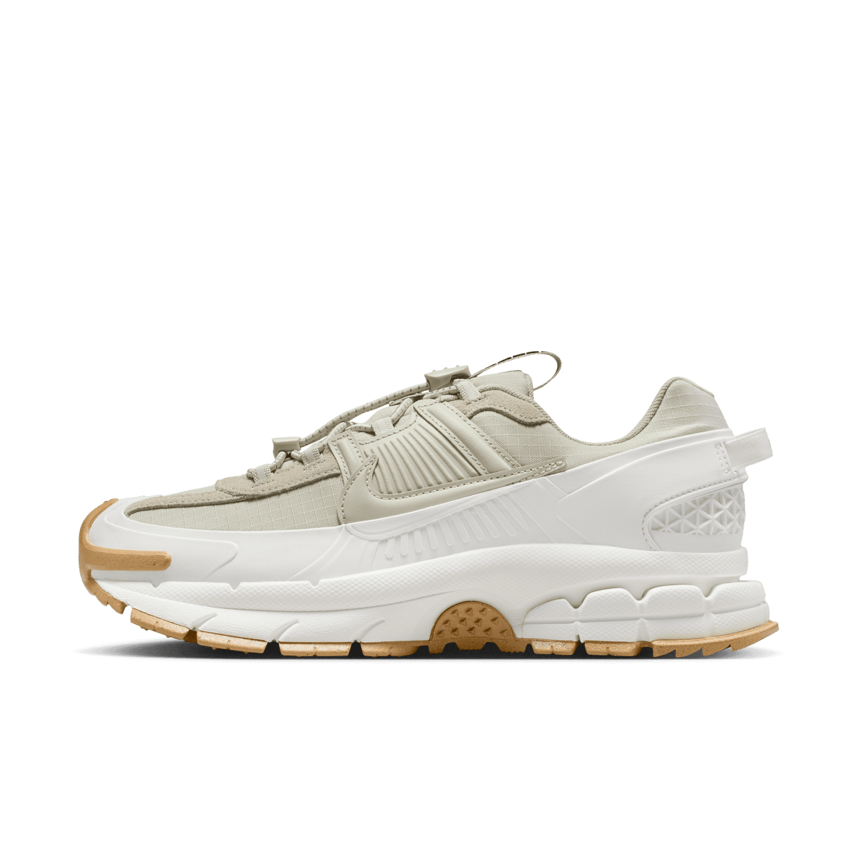 Lateral view of a light stone and sail Nike Zoom Vomero 5 sneaker with a chunky white midsole and gum rubber outsole.
