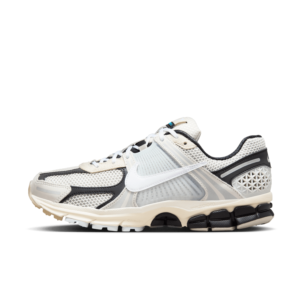 Right lateral view of a Nike Zoom Vomero 5 sneaker in light bone and black with a white swoosh and chunky multi-layer midsole.