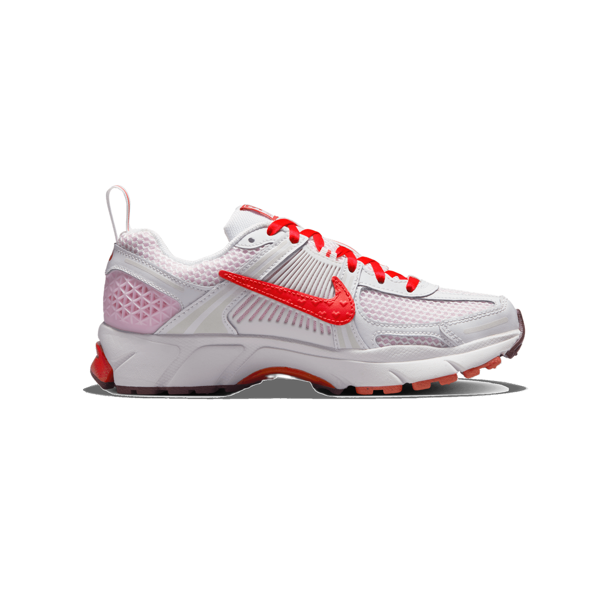 Side profile of a white and pink Nike Zoom Vomero 5 sneaker with red laces and a red Swoosh logo on the mesh upper, toe pointing left.