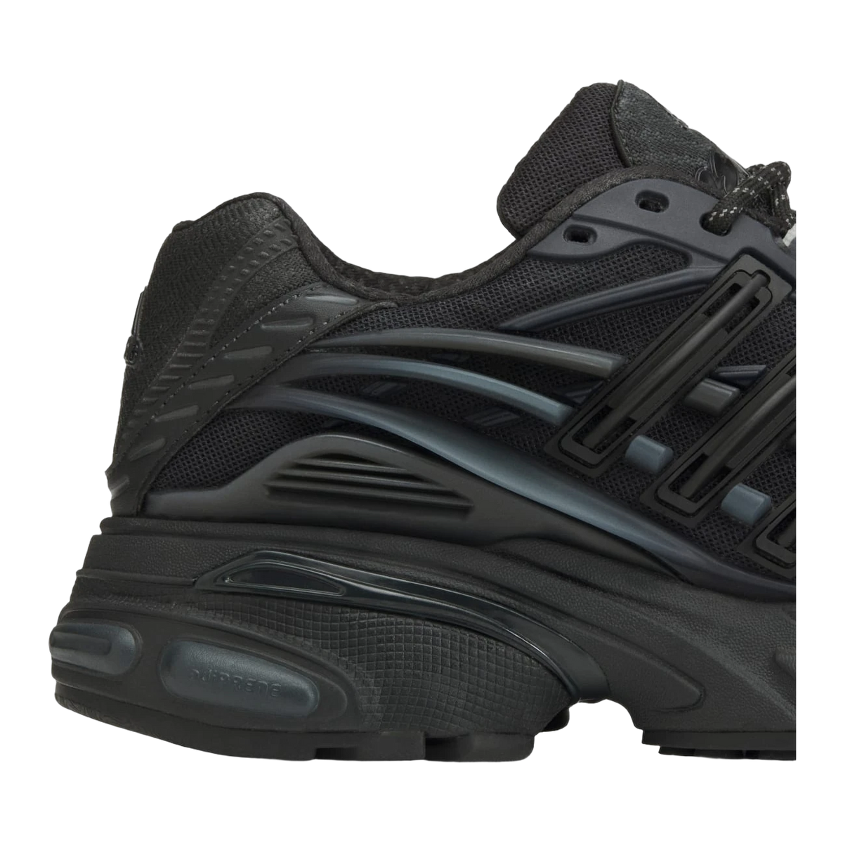 Close-up side view of a black Adidas Adistar Jellyfish sneaker showing textured overlays, mesh upper, and ridged midsole cushioning detail.