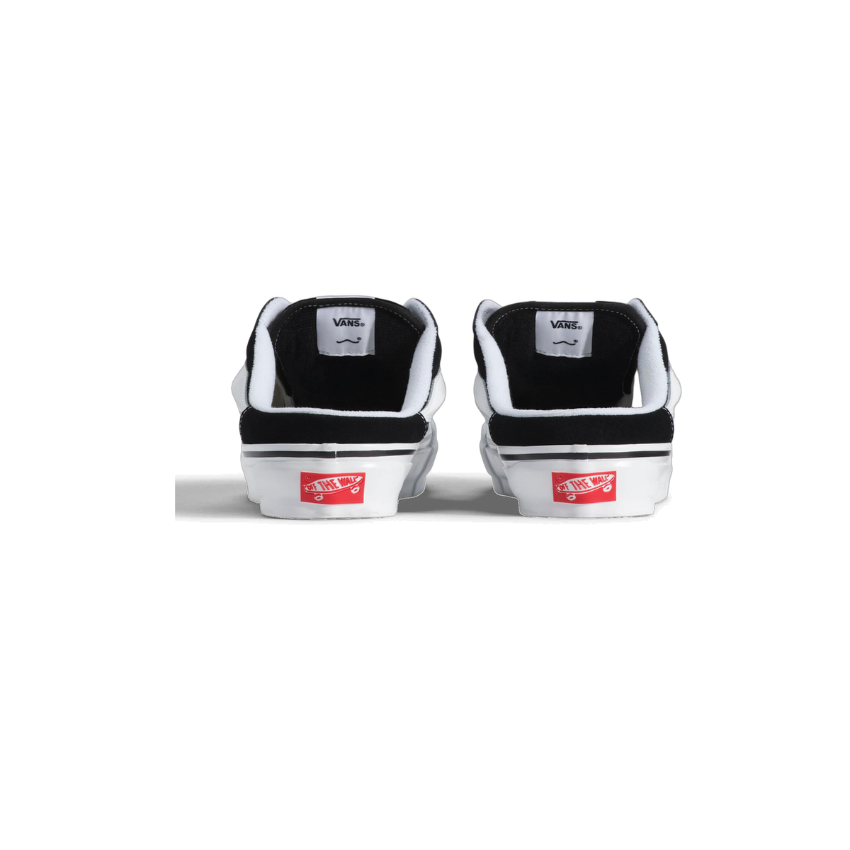 Rear view of a pair of black and white Vans Knu Skool mules showing the heel pull tabs with Vans branding and red Off The Wall logo patches on the white midsoles