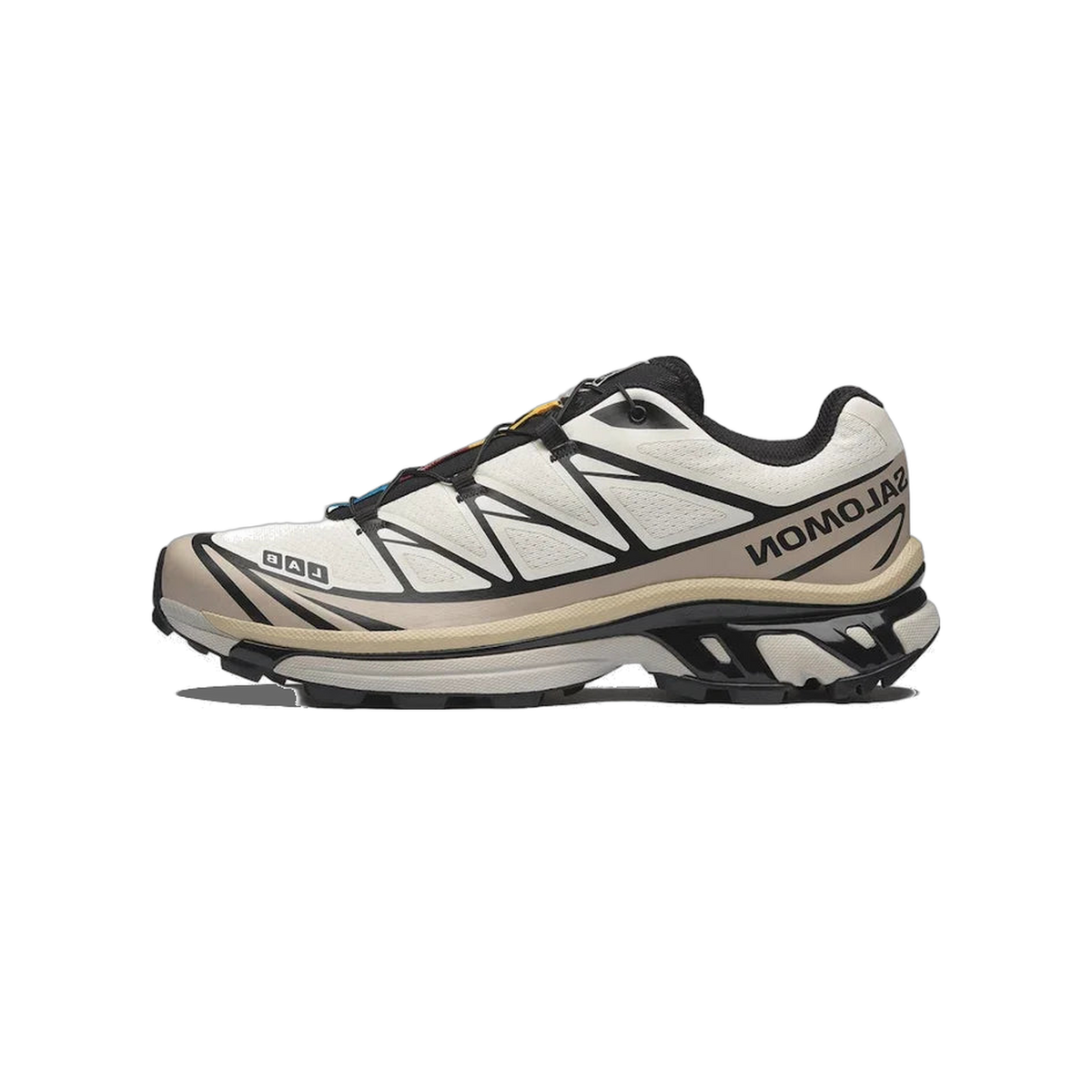 Side view of a white Salomon XT-6 trail shoe with black overlays, tan midsole trim, quick-lace toggle, and multicolored lace loops, toe pointing left.