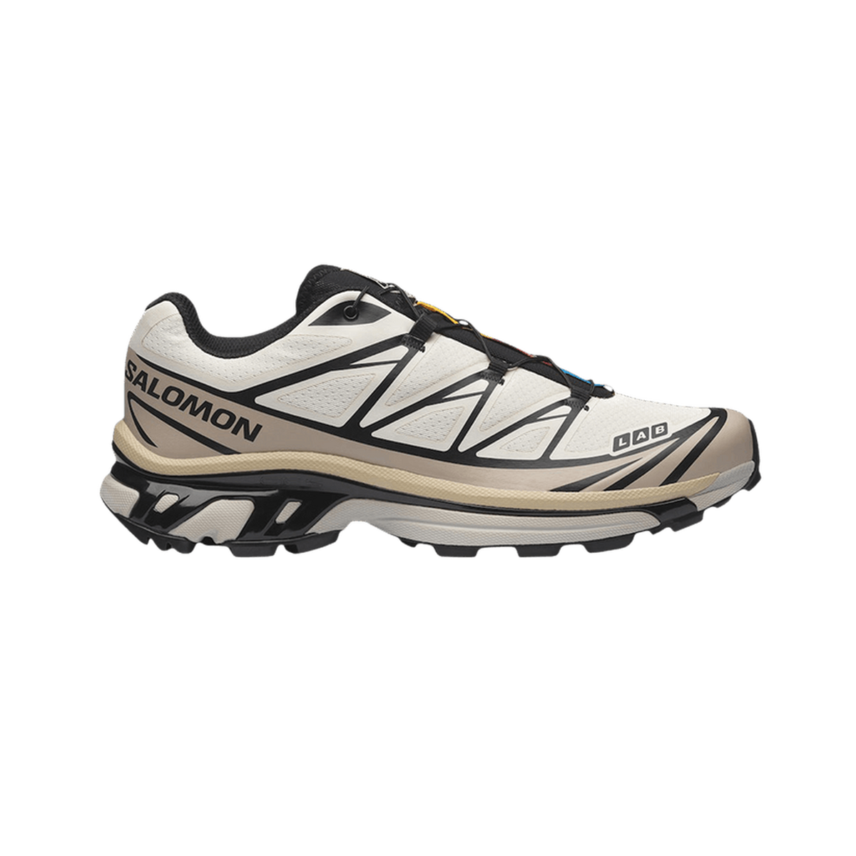 Right-side profile view of a white and black Salomon XT-6 trail sneaker with tan midsole, black speed-lace system, and black Salomon branding on the lateral side, toe pointing right