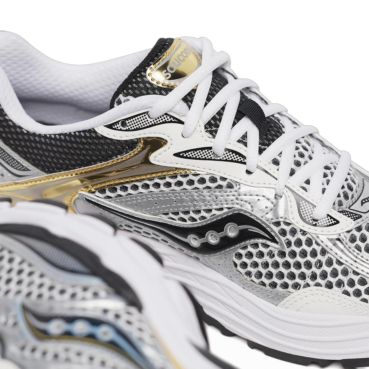 Close-up angled view of a Saucony ProGrid Omni 9 sneaker showing the mesh upper, silver overlays, gold heel branding, and black laces with white eyelets.