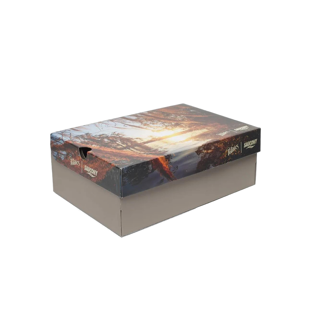 Shoe box featuring a forest sunset design on the lid with Politics and Saucony logos printed on the side.