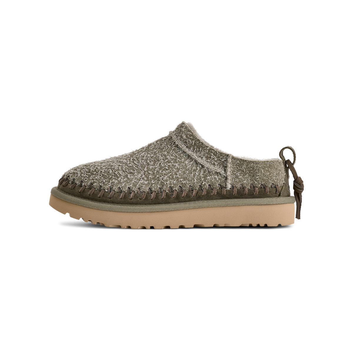 Side view of a green UGG Classic Micro Biarritz slip-on clog with textured wool-like upper, whipstitch trim, pull tab, and tan lugged sole, toe facing left.