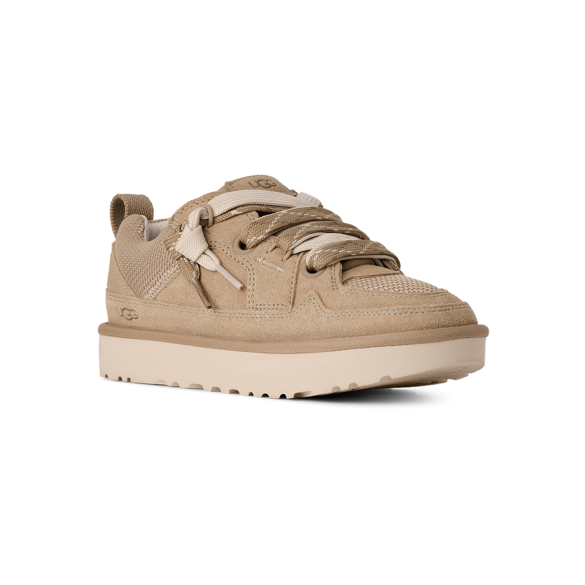 Tan suede UGG Lowmel Lo sneaker shown at an angle with toe pointing left, featuring thick patterned laces, UGG logo on the side, and a chunky ridged sole.
