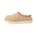 Side view of a beige suede UGG Tasman II slipper with red and white embroidered trim around the collar and a cream rubber outsole.