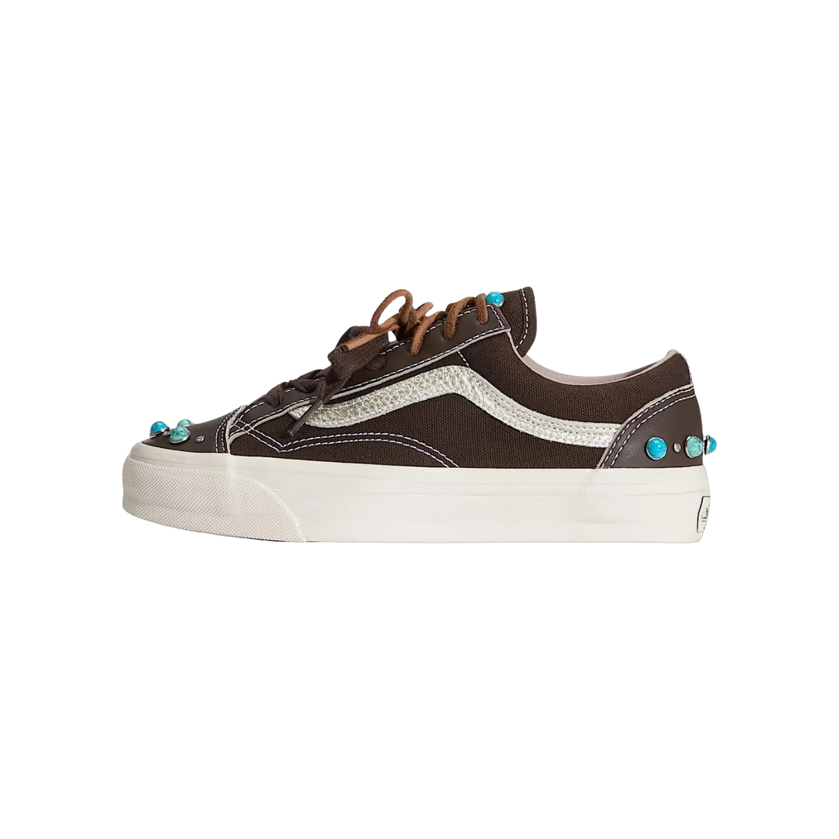 Side view of a brown Vans Old Skool sneaker with cream sidestripe, tan laces, off-white sole, and turquoise bead embellishments near the toe and heel