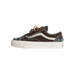 Side view of a brown Vans Old Skool sneaker with cream sidestripe, tan laces, off-white sole, and turquoise bead embellishments near the toe and heel