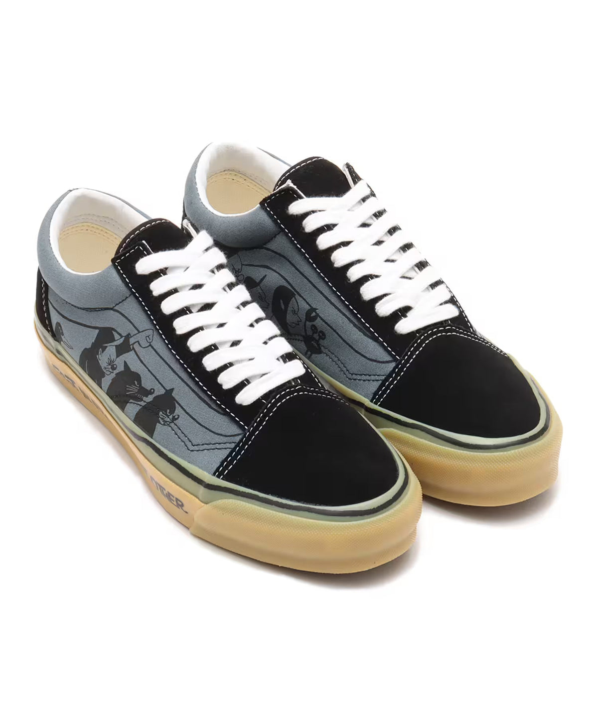 Pair of Vans Old Skool sneakers with black toe caps and heels, grey side panels featuring black animal graphic prints, white laces, and gum soles printed with 'DANGER' text.