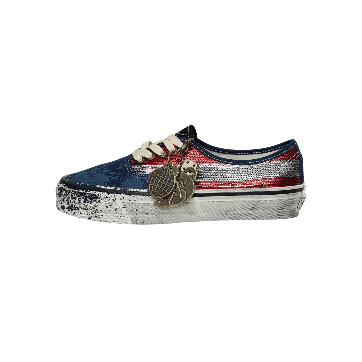 Side view of a Vans Authentic sneaker with a navy toe and heel, red and silver sequined sidewall, distressed splattered midsole, and metal charms hanging from the laces
