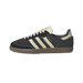 Side view of a black suede Adidas Samba OG sneaker with cream leather three stripes, heel tab, and tongue, gum rubber outsole