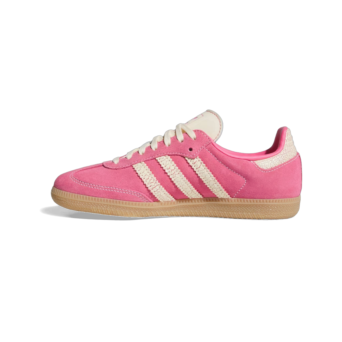 Side view of a pink suede adidas Samba sneaker with cream cracked-texture stripes, cream laces, and a gum rubber sole