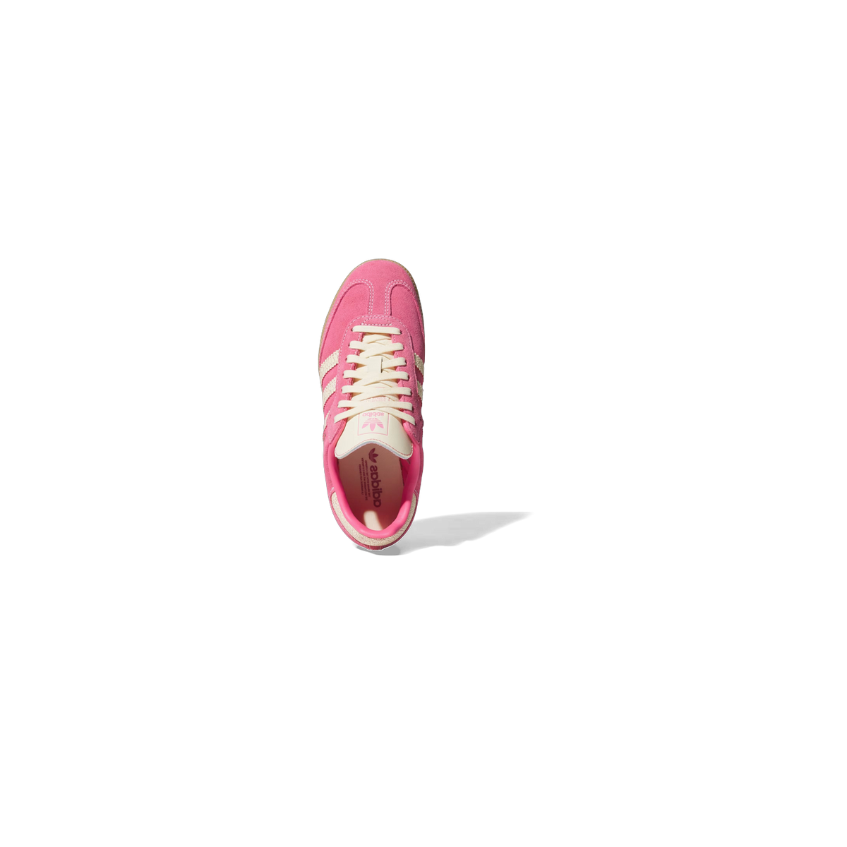 Top-down view of a pink suede adidas Samba sneaker with cream three stripes, laces, and gum sole, showing the open interior lined in pink.