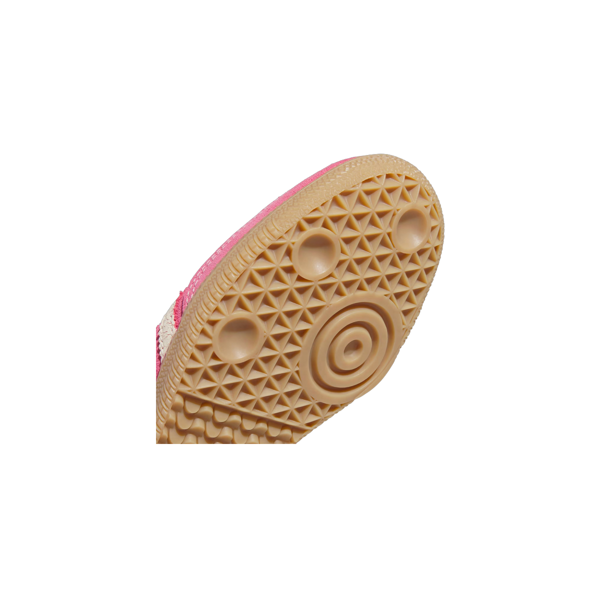 Close-up of the gum rubber outsole with circular tread pattern on a pink adidas Samba OG sneaker.