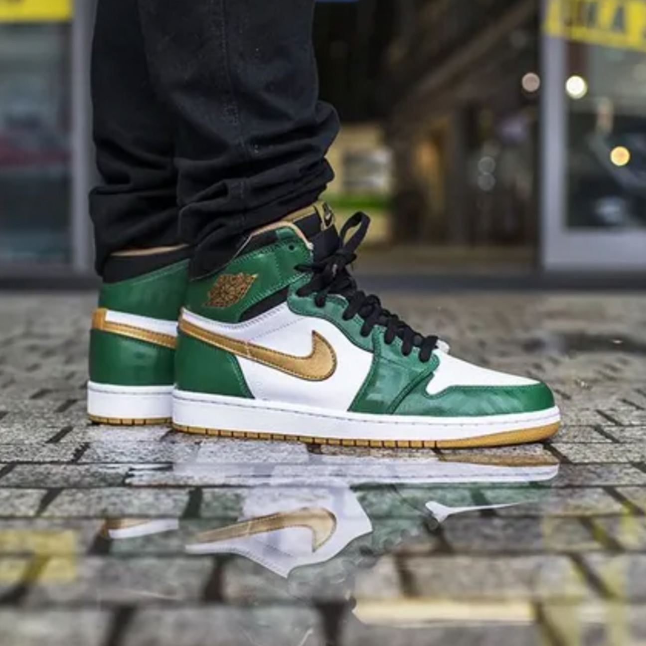 Air Jordan 1 High OG Celtics sneaker with green and black leather upper and classic Air Jordan branding