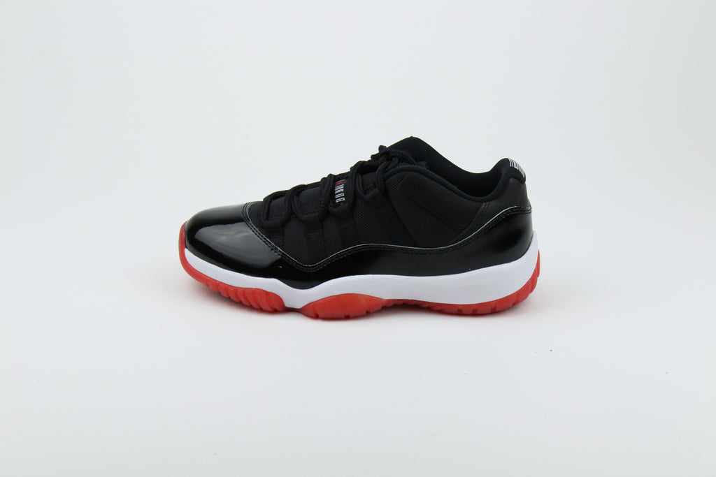 Air Jordan 11 Retro Low ‘Bred’ – iconic low-top basketball sneakers with a classic black and red colourway, premium patent leather upper, and cushioned sole, perfect for style and performance.