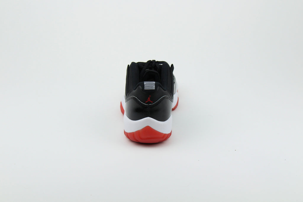 Air Jordan 11 Retro Low ‘Bred’ – iconic low-top basketball sneakers with a classic black and red colourway, premium patent leather upper, and cushioned sole, perfect for style and performance.