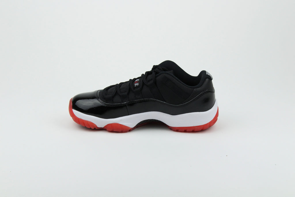 Air Jordan 11 Retro Low ‘Bred’ – iconic low-top basketball sneakers with a classic black and red colourway, premium patent leather upper, and cushioned sole, perfect for style and performance.