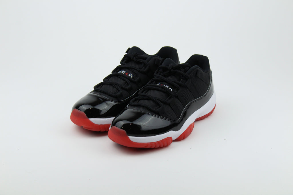 Air Jordan 11 Retro Low ‘Bred’ – iconic low-top basketball sneakers with a classic black and red colourway, premium patent leather upper, and cushioned sole, perfect for style and performance.