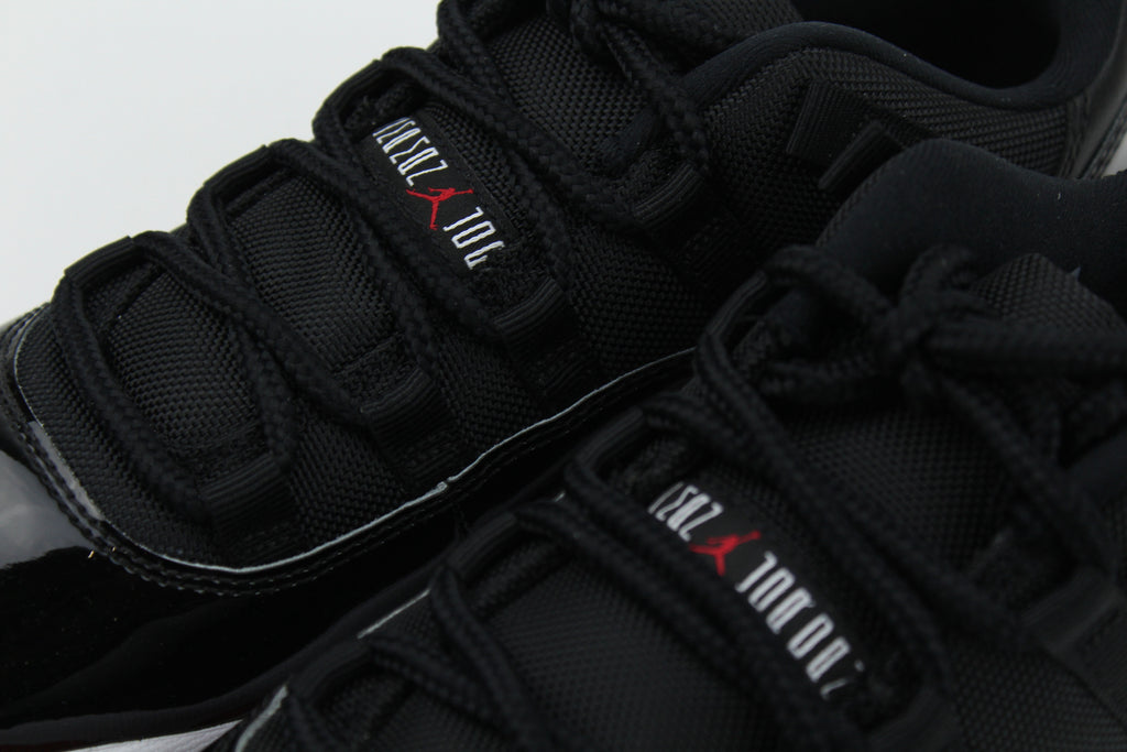 Air Jordan 11 Retro Low ‘Bred’ – iconic low-top basketball sneakers with a classic black and red colourway, premium patent leather upper, and cushioned sole, perfect for style and performance.