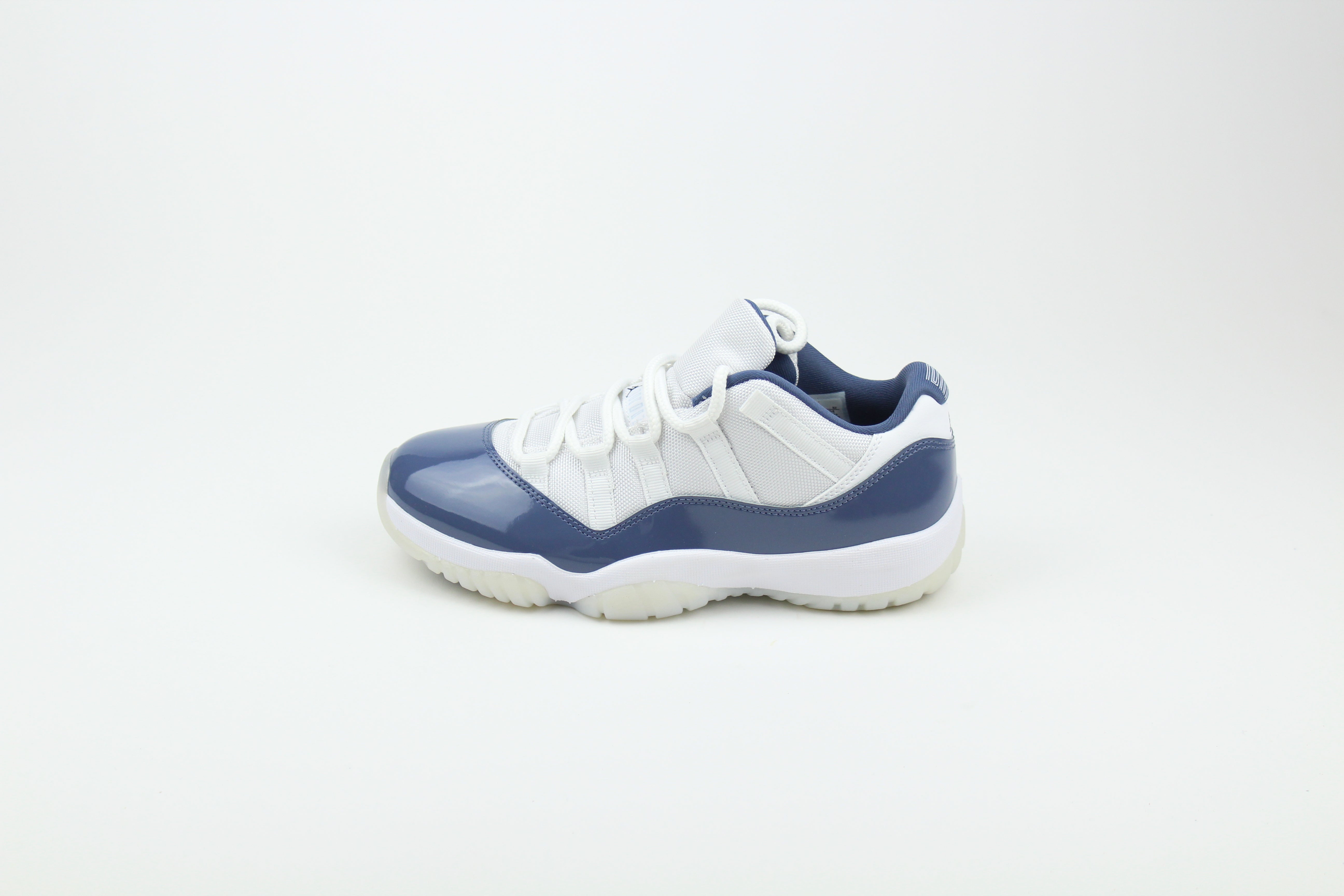 Air Jordan 11 Retro Low Diffused Blue sneakers side view, white leather with blue accents, iconic low-top basketball shoe, premium athletic footwear, stylish and collectible