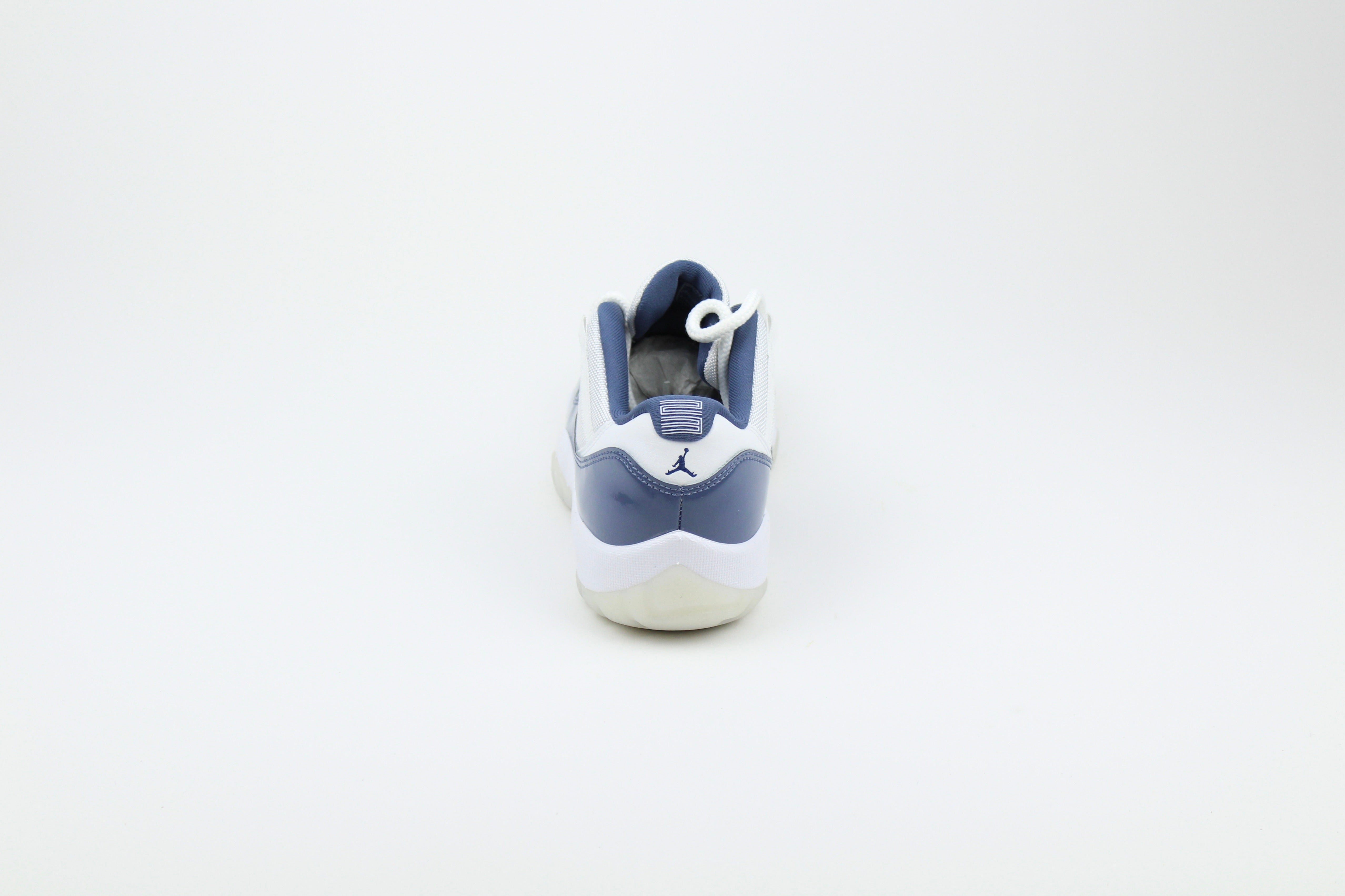 Air Jordan 11 Retro Low Diffused Blue sneakers side view, white leather with blue accents, iconic low-top basketball shoe, premium athletic footwear, stylish and collectible