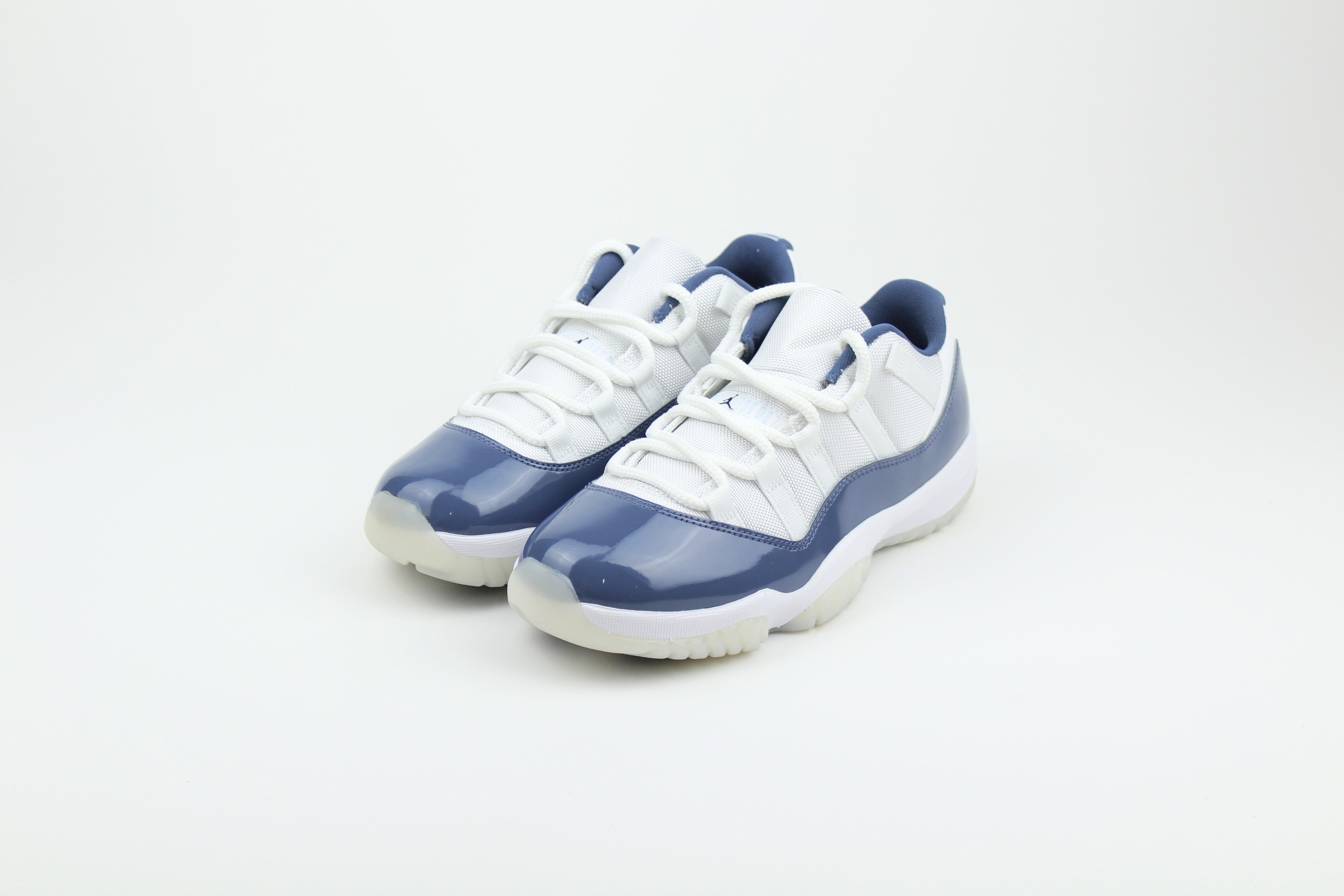 Air Jordan 11 Retro Low Diffused Blue sneakers side view, white leather with blue accents, iconic low-top basketball shoe, premium athletic footwear, stylish and collectible