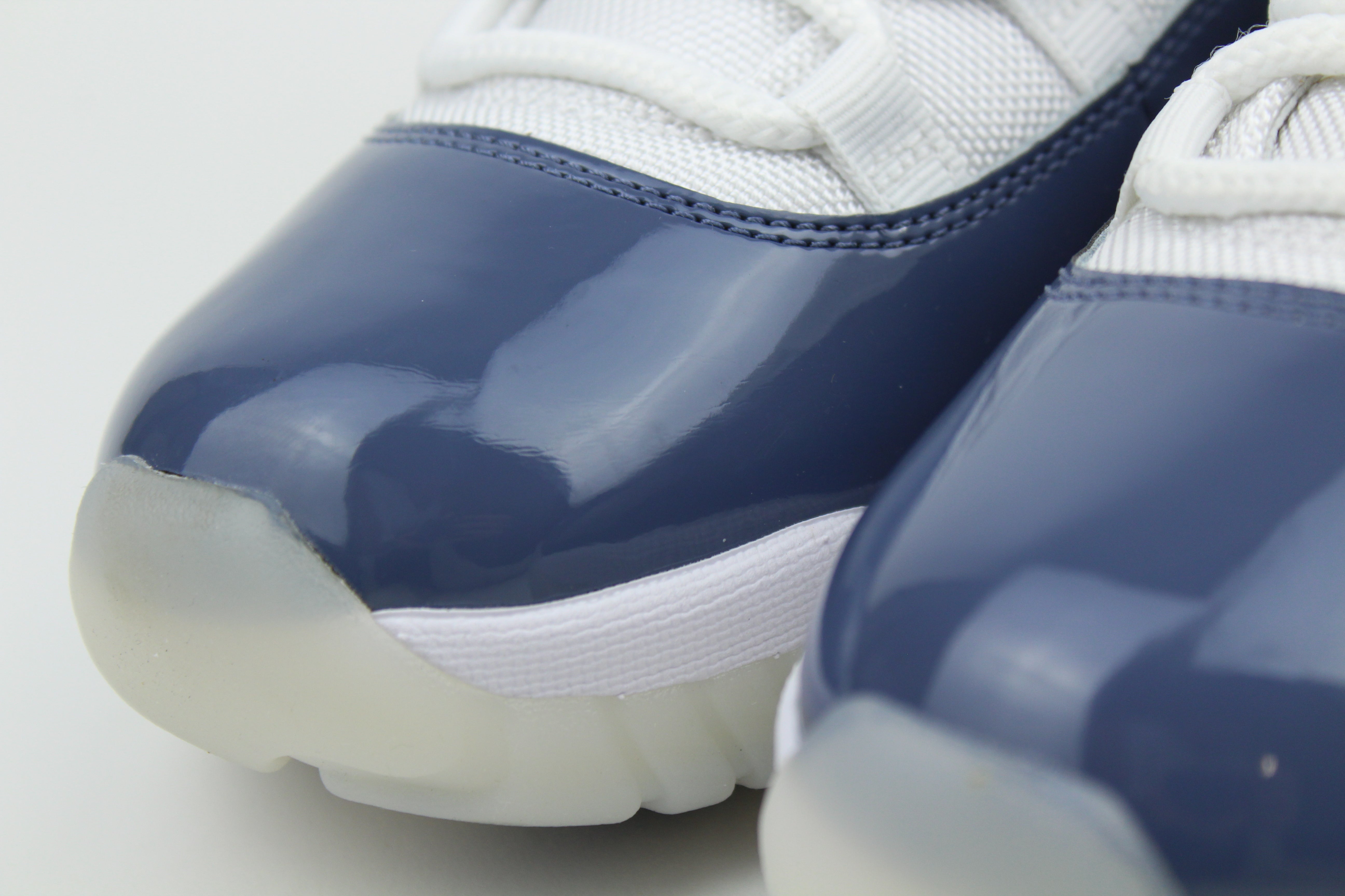 Air Jordan 11 Retro Low Diffused Blue sneakers side view, white leather with blue accents, iconic low-top basketball shoe, premium athletic footwear, stylish and collectible
