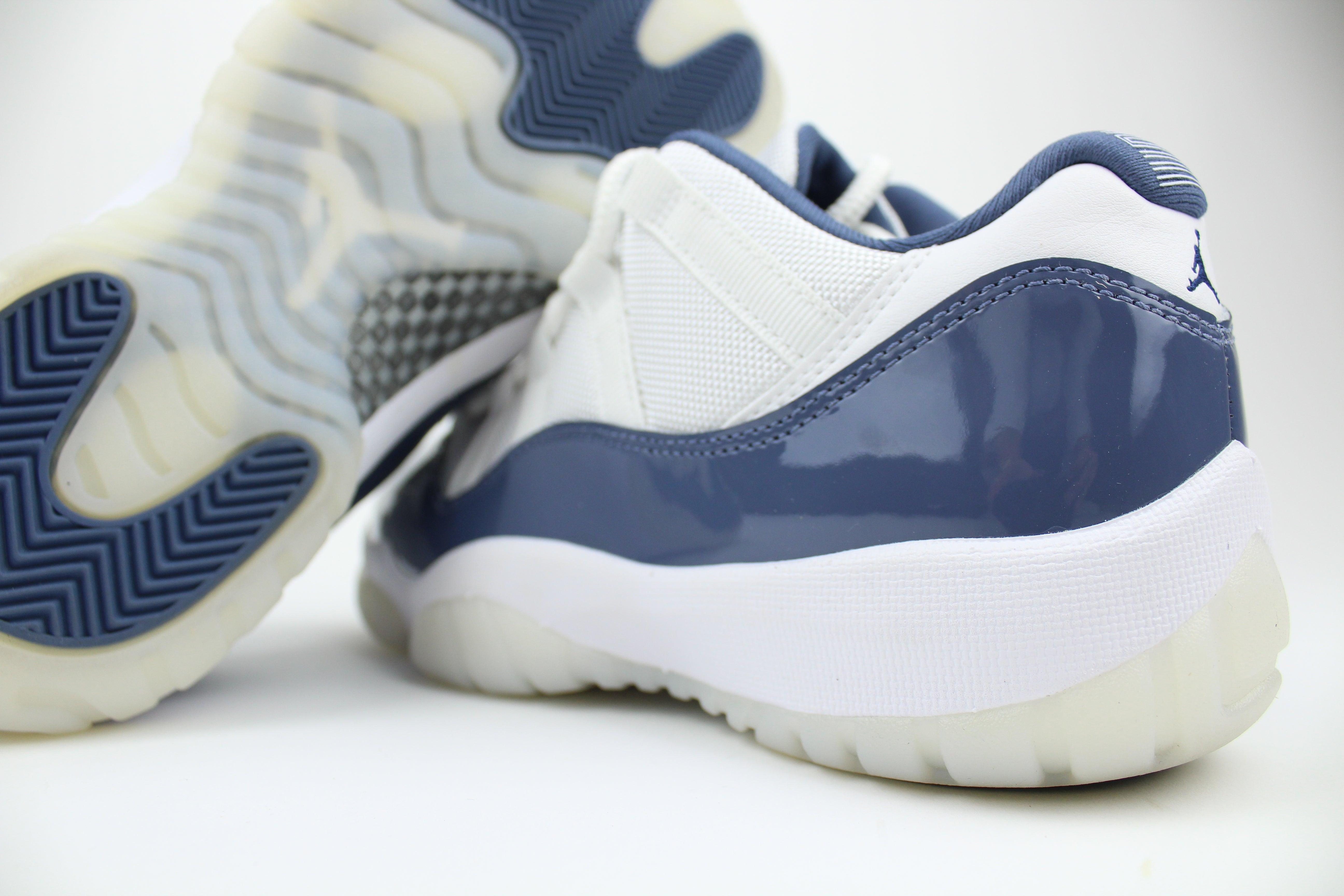 Air Jordan 11 Retro Low Diffused Blue sneakers side view, white leather with blue accents, iconic low-top basketball shoe, premium athletic footwear, stylish and collectible
