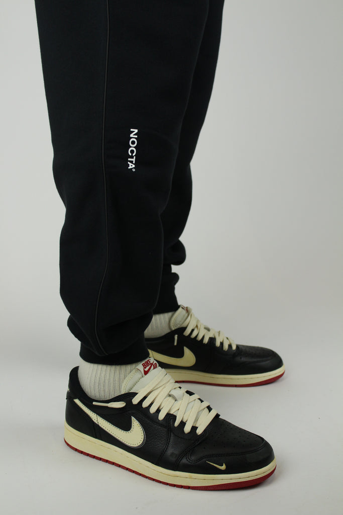 The Nike x NOCTA Open-Hem Fleece Pants Tapered in Black are the definition of effortless utility With a tailored straight-leg fit and clean finish.