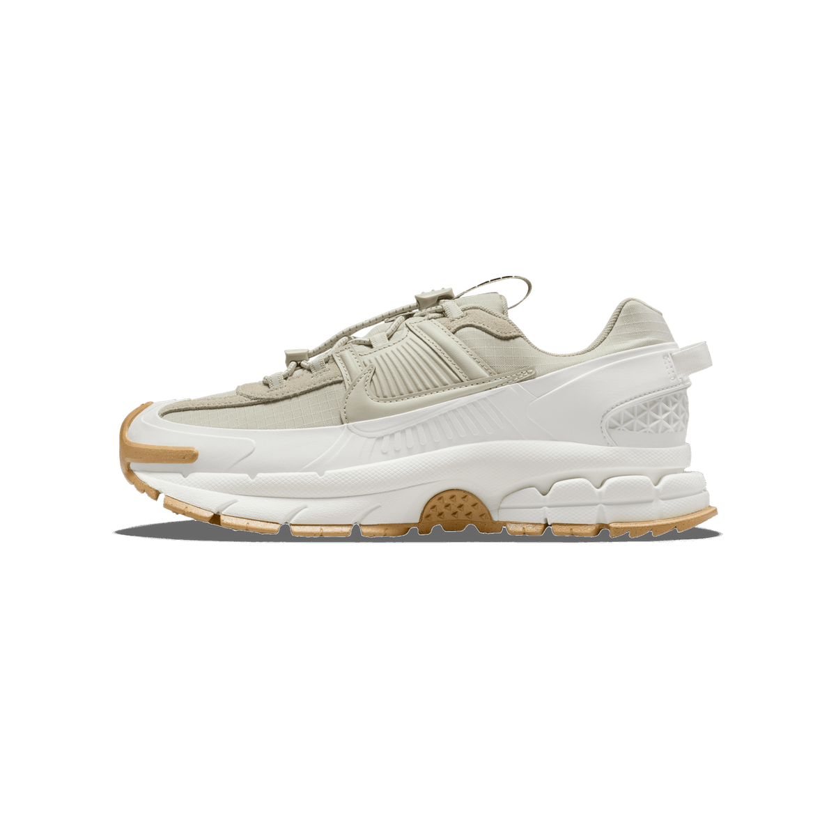 Lateral view of a light stone and sail Nike Zoom Vomero 5 sneaker with a chunky white midsole and gum rubber outsole.