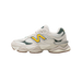 Side view of a cream New Balance 9060 sneaker with a yellow and dark green 'N' logo, green heel accent, and gum sole.