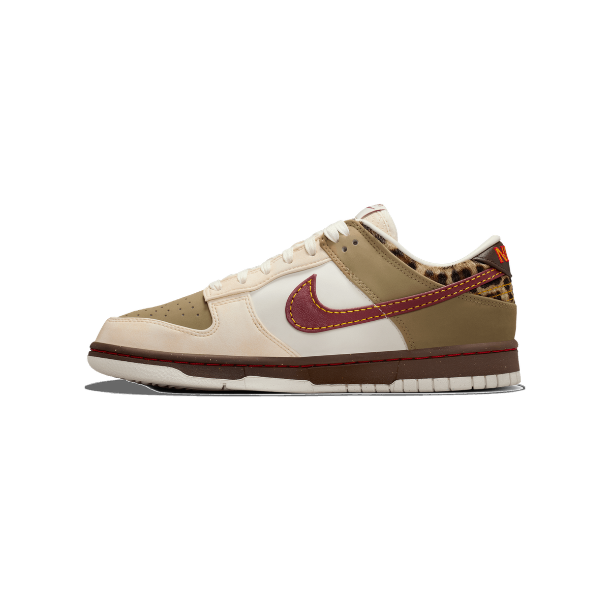 Side view of a Nike Dunk Low sneaker in khaki, cream, and white with a dark red swooth, leopard print heel panel, and brown midsole.