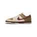 Side view of a Nike Dunk Low sneaker in khaki, cream, and white with a dark red swooth, leopard print heel panel, and brown midsole.