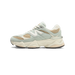 Left New Balance 9060 sneaker in sage green suede and tan mesh with white N logo, cream midsole, and tan outsole, shown from the side with toe pointing left