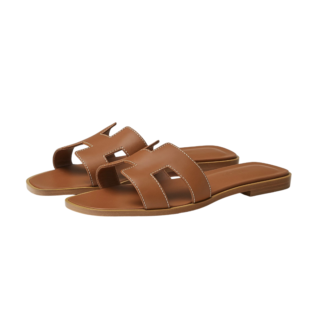 Hermes Oran Sandal in brown leather with minimalist design, open toe, flat sole, and slip-on style, luxury summer footwear