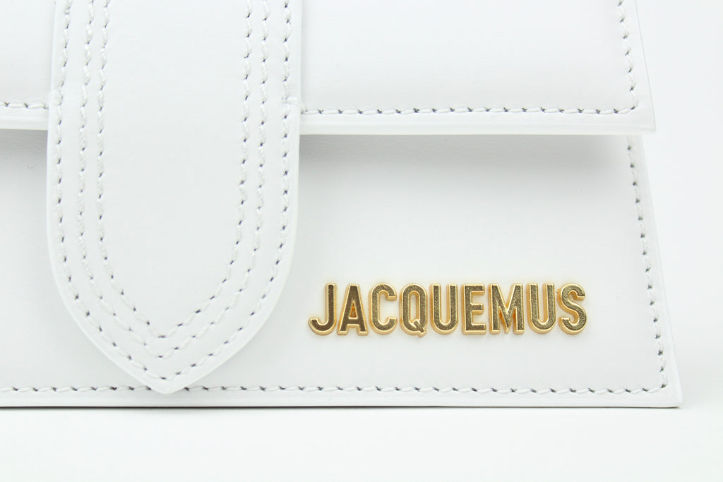 Discover the Jacquemus Le Bambino Top Handle Bag Small 'White' – a compact leather handbag with a sleek silhouette, versatile styling, and timeless minimalist elegance.
