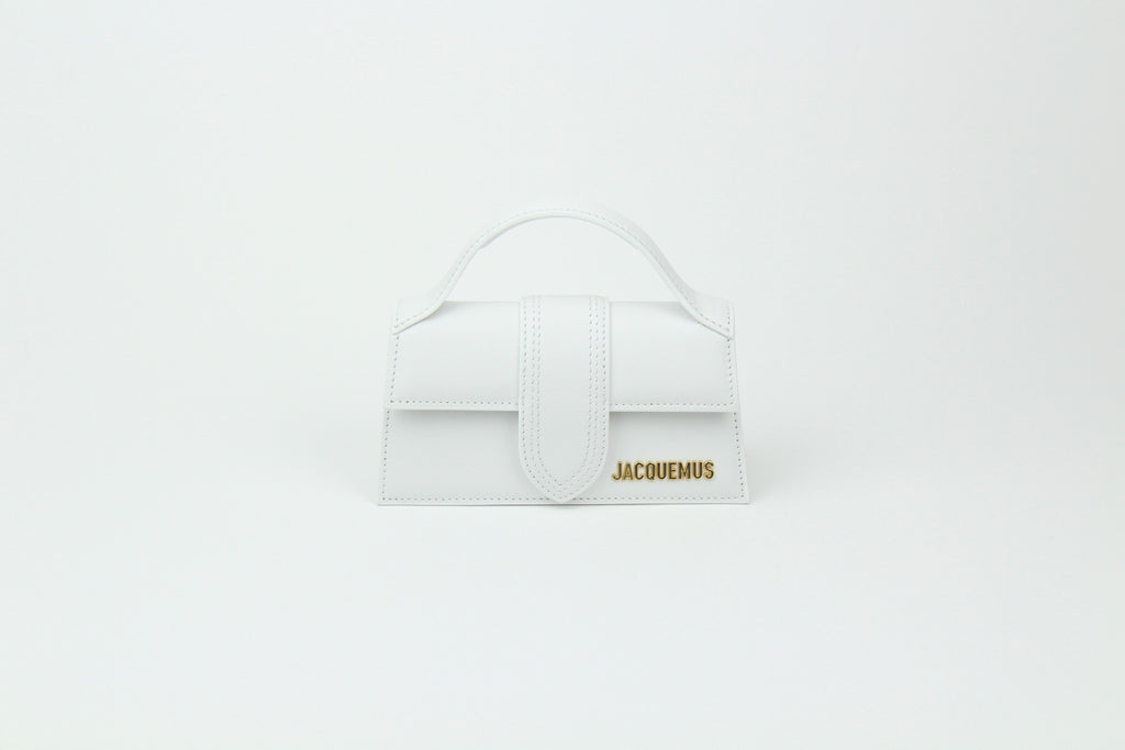 Discover the Jacquemus Le Bambino Top Handle Bag Small 'White' – a compact leather handbag with a sleek silhouette, versatile styling, and timeless minimalist elegance.