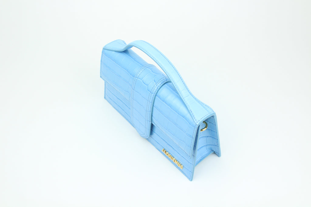 Jacquemus Le Grand Bambino 'Light Blue Croco' blends croc-embossed leather with fresh color and clean design. A structured, elegant accessory for standout everyday wear.