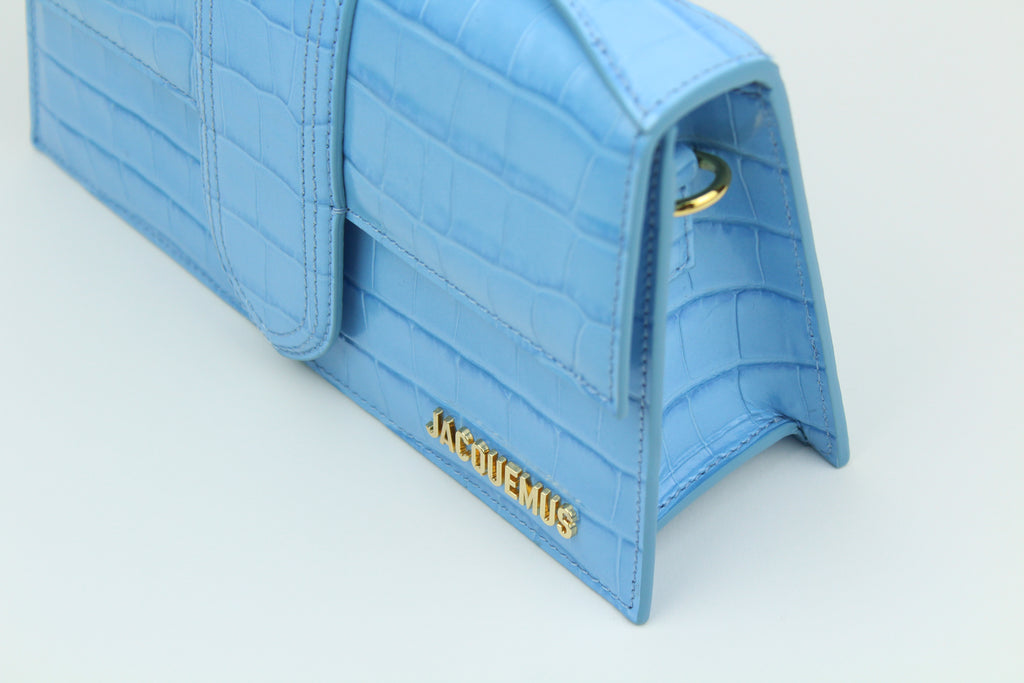 Jacquemus Le Grand Bambino 'Light Blue Croco' blends croc-embossed leather with fresh color and clean design. A structured, elegant accessory for standout everyday wear.