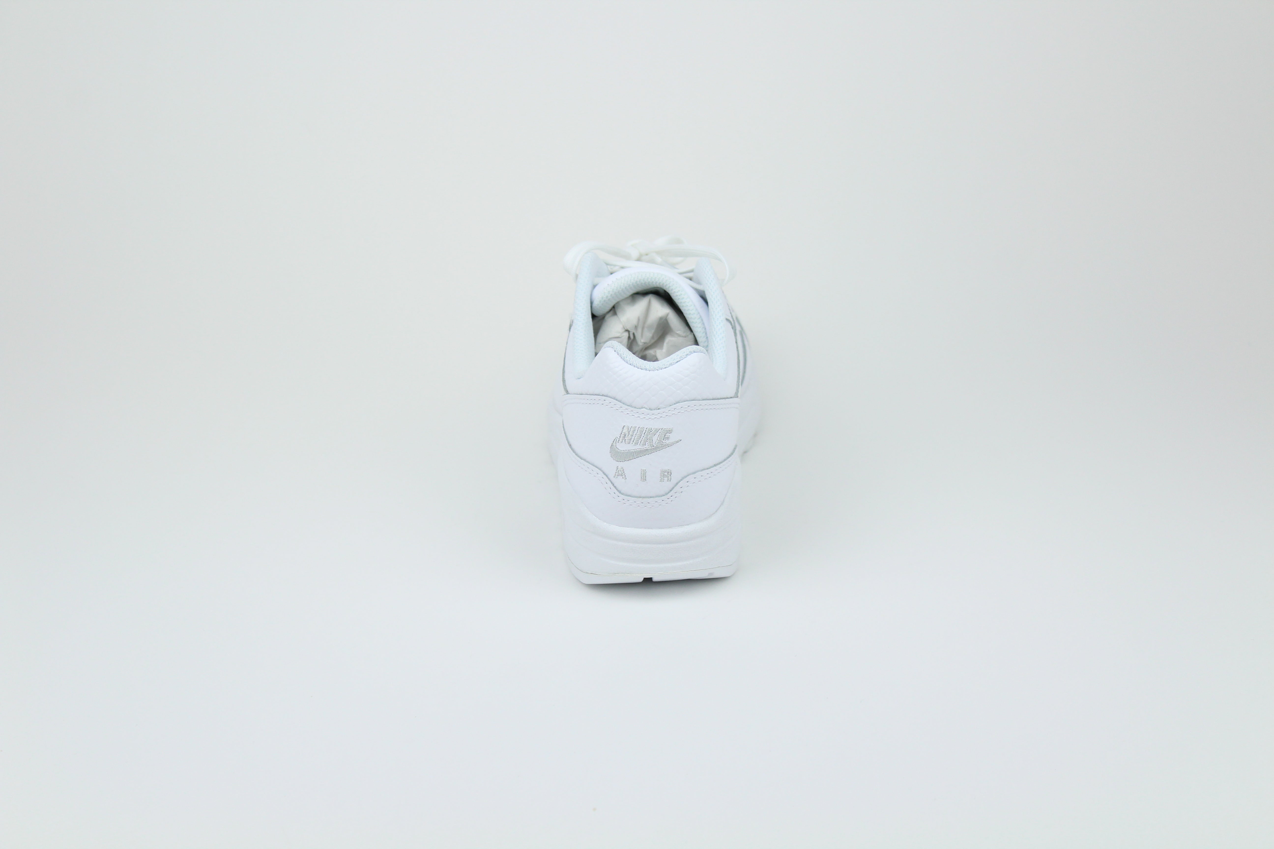 Nike Air Max 1 PRM Snakeskin sneakers in 'Triple White' colorway, premium white athletic shoes with snakeskin detailing, ideal for casual and stylish outfits.