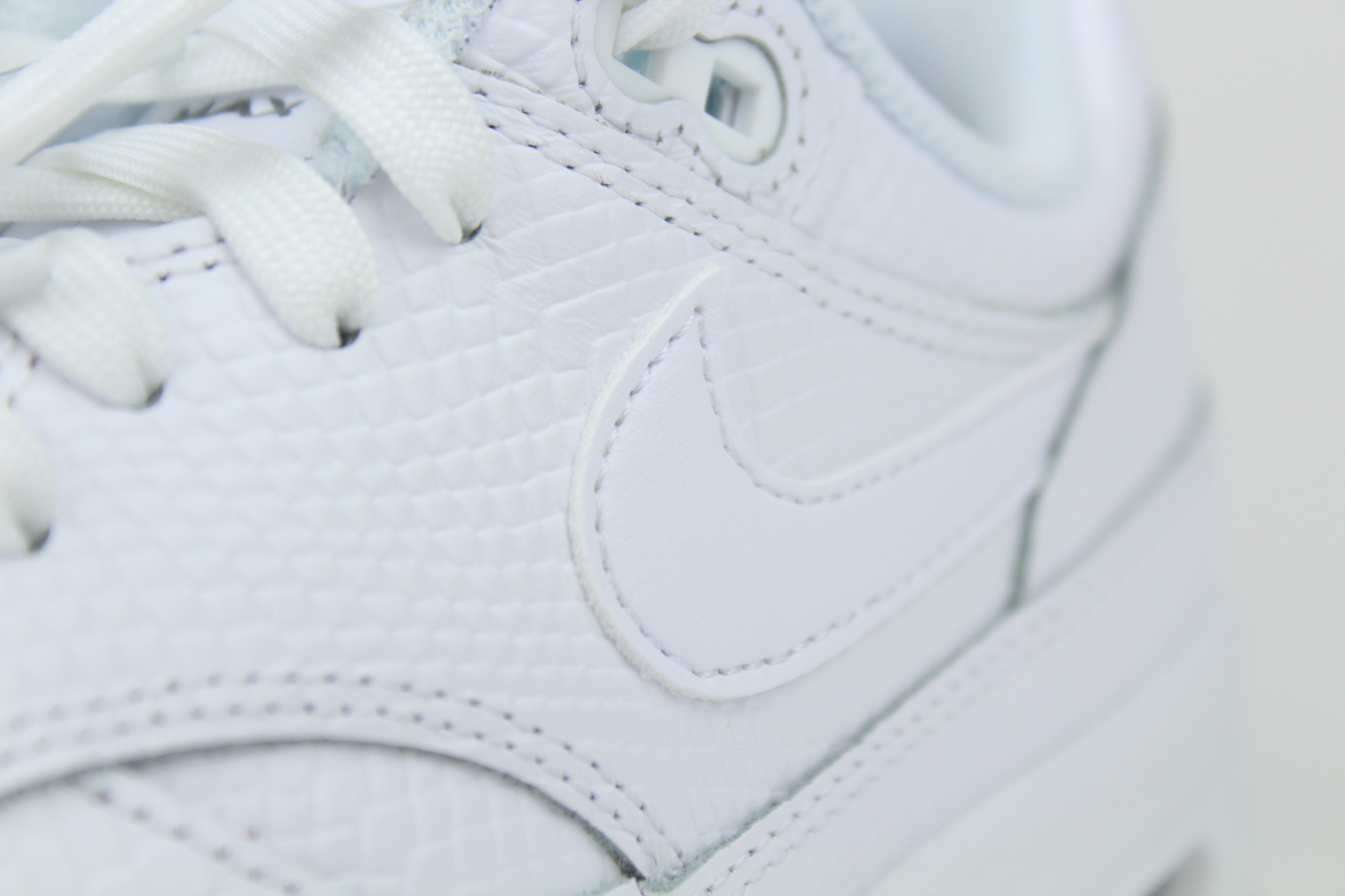 Nike Air Max 1 PRM Snakeskin sneakers in 'Triple White' colorway, premium white athletic shoes with snakeskin detailing, ideal for casual and stylish outfits.