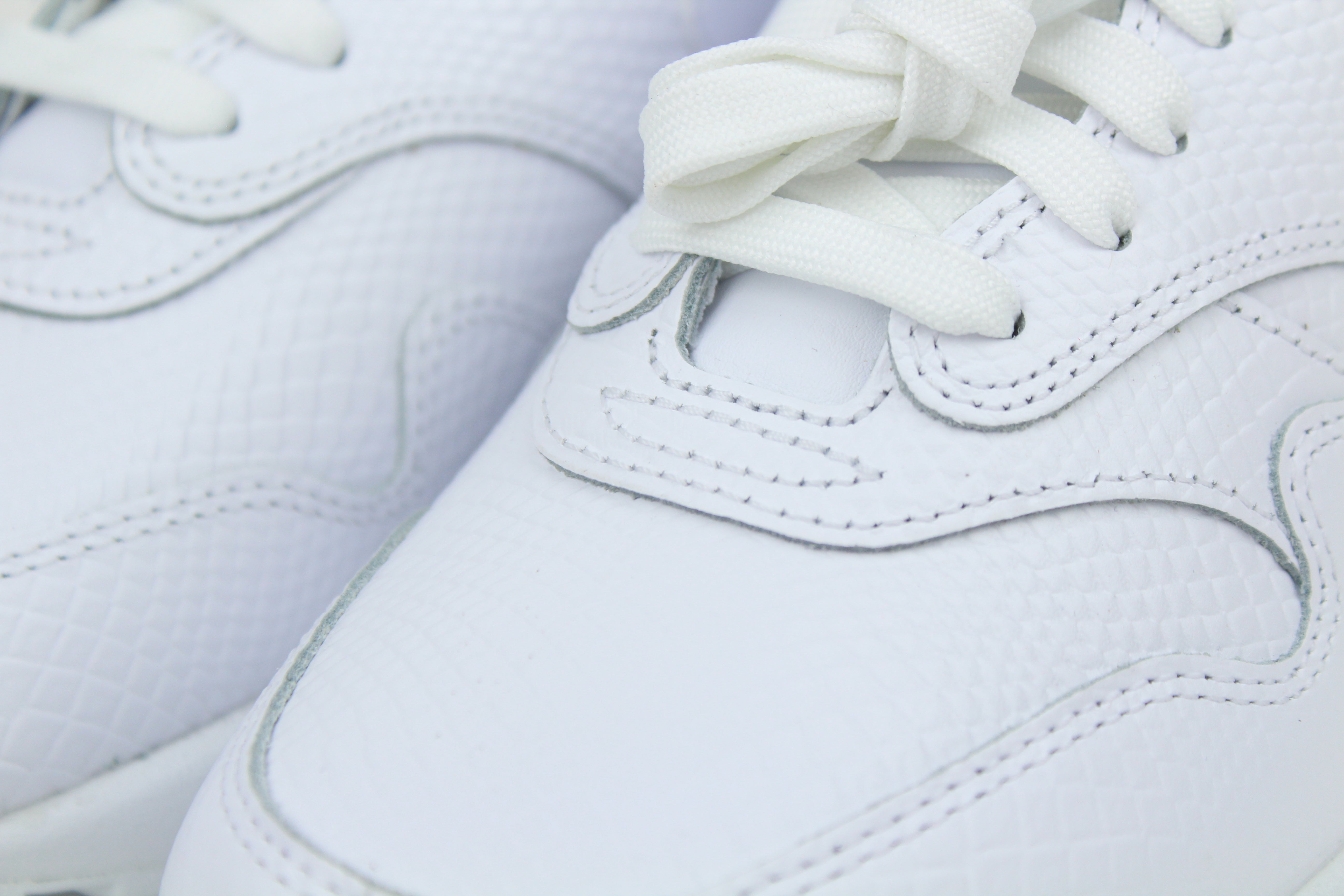 Nike Air Max 1 PRM Snakeskin sneakers in 'Triple White' colorway, premium white athletic shoes with snakeskin detailing, ideal for casual and stylish outfits.