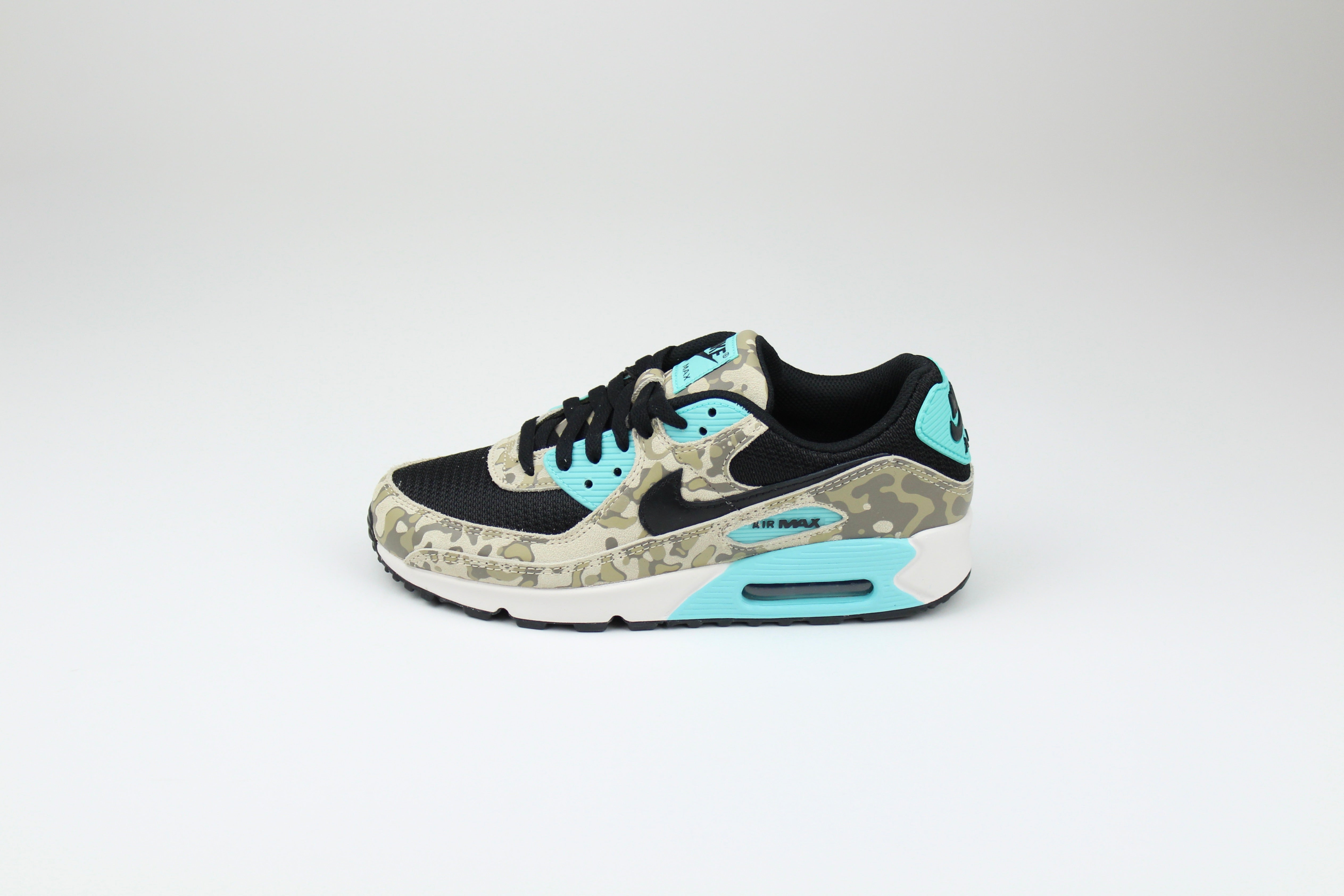 Nike Air Max 90 ‘Aurora Green’ from the 2025 Camo Pack with layered materials and bright green accents. Style with cargos and clean layers for rugged yet polished streetwear.