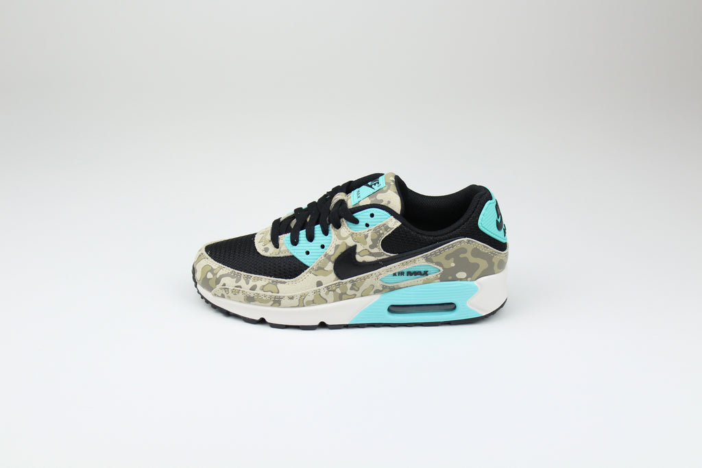 Nike Air Max 90 ‘Aurora Green’ from the 2025 Camo Pack with layered materials and bright green accents. Style with cargos and clean layers for rugged yet polished streetwear.