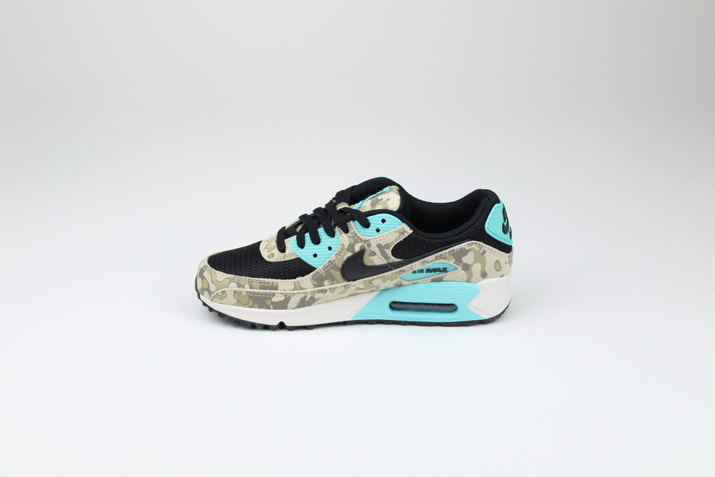 Nike Air Max 90 ‘Aurora Green’ from the 2025 Camo Pack with layered materials and bright green accents. Style with cargos and clean layers for rugged yet polished streetwear.