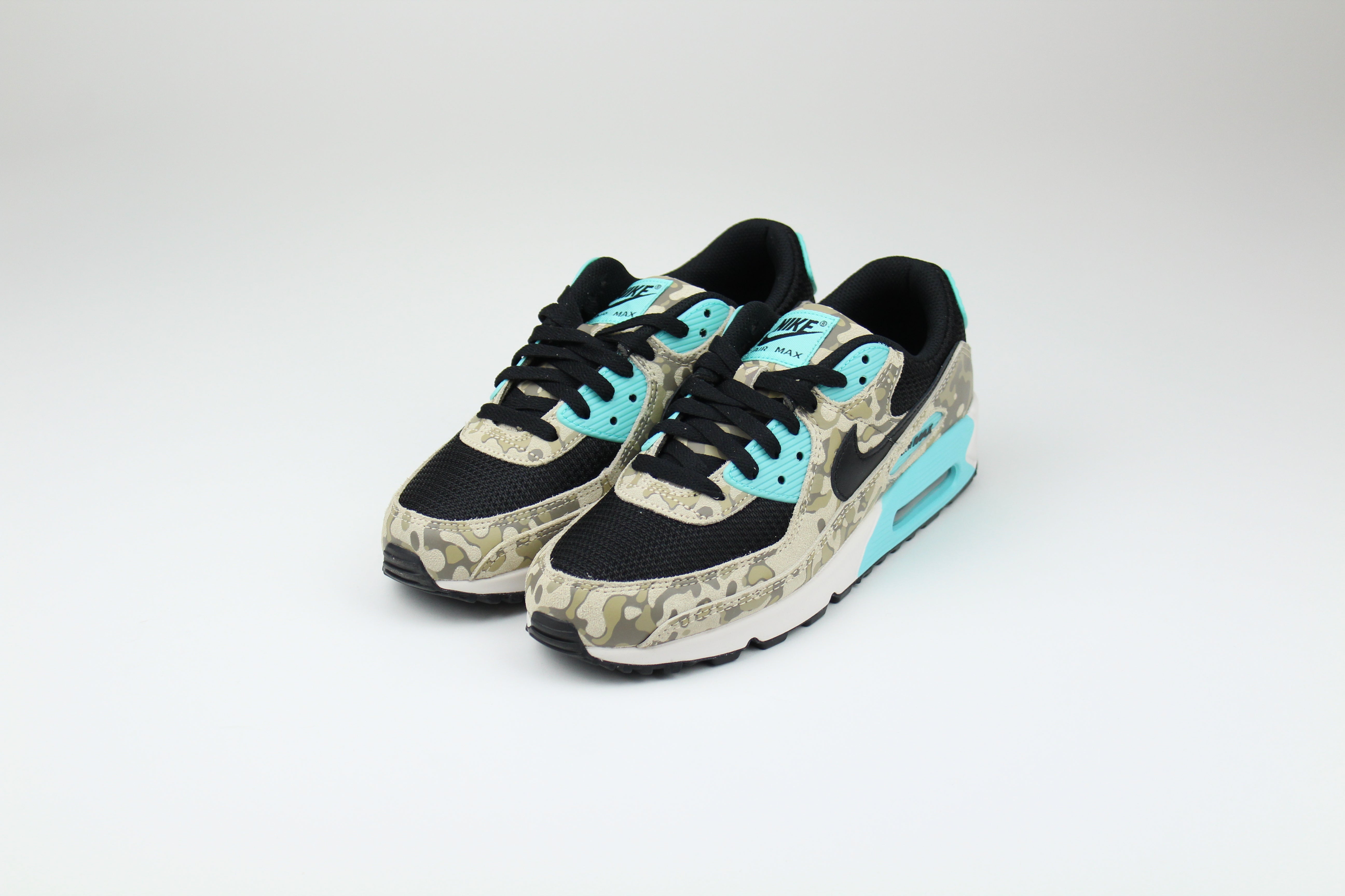 Nike Air Max 90 ‘Aurora Green’ from the 2025 Camo Pack with layered materials and bright green accents. Style with cargos and clean layers for rugged yet polished streetwear.