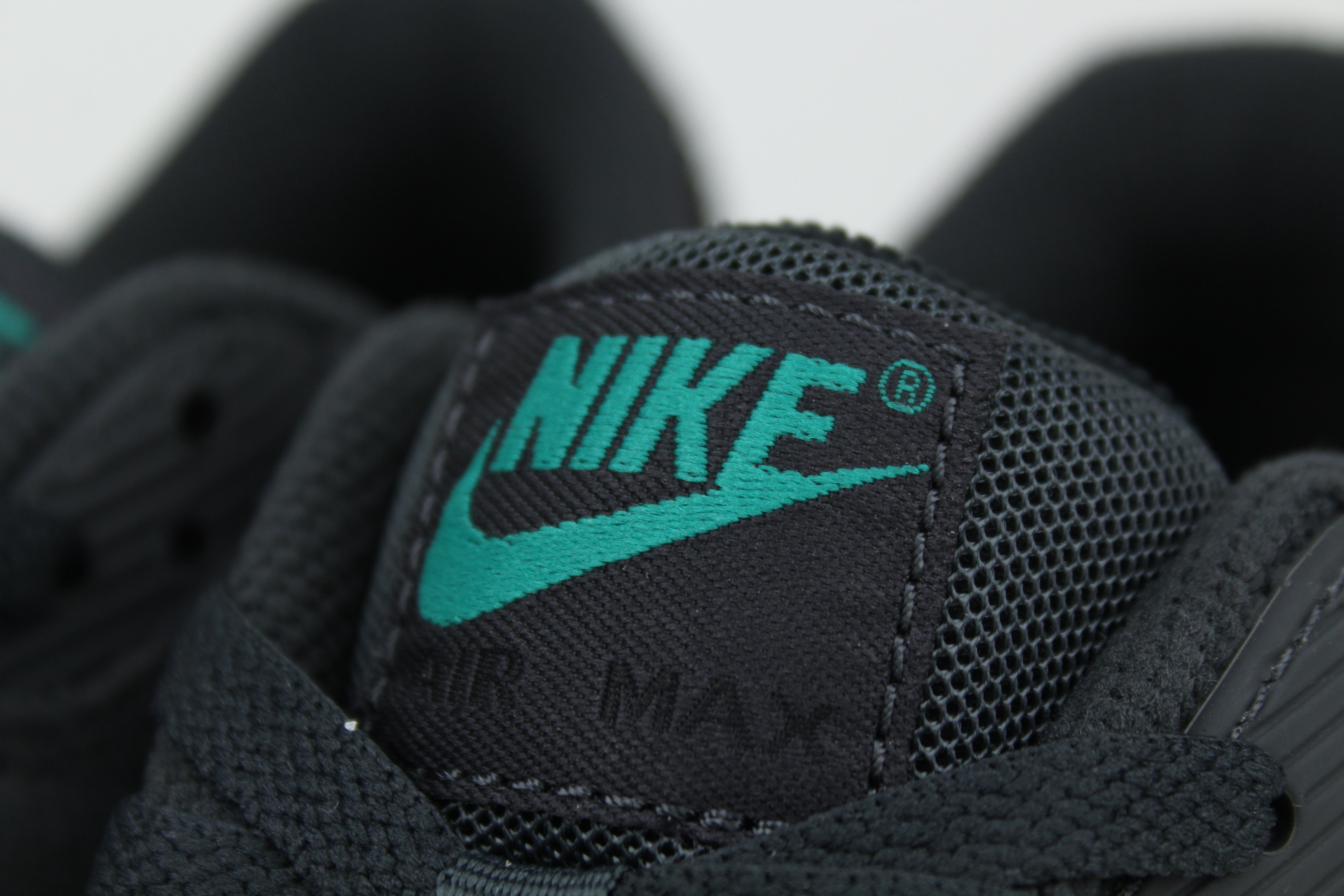 Nike Air Max 90 sneakers in 'Black Tiffany' colorway, bold black and Tiffany blue athletic shoes, perfect for casual and sporty styles.

